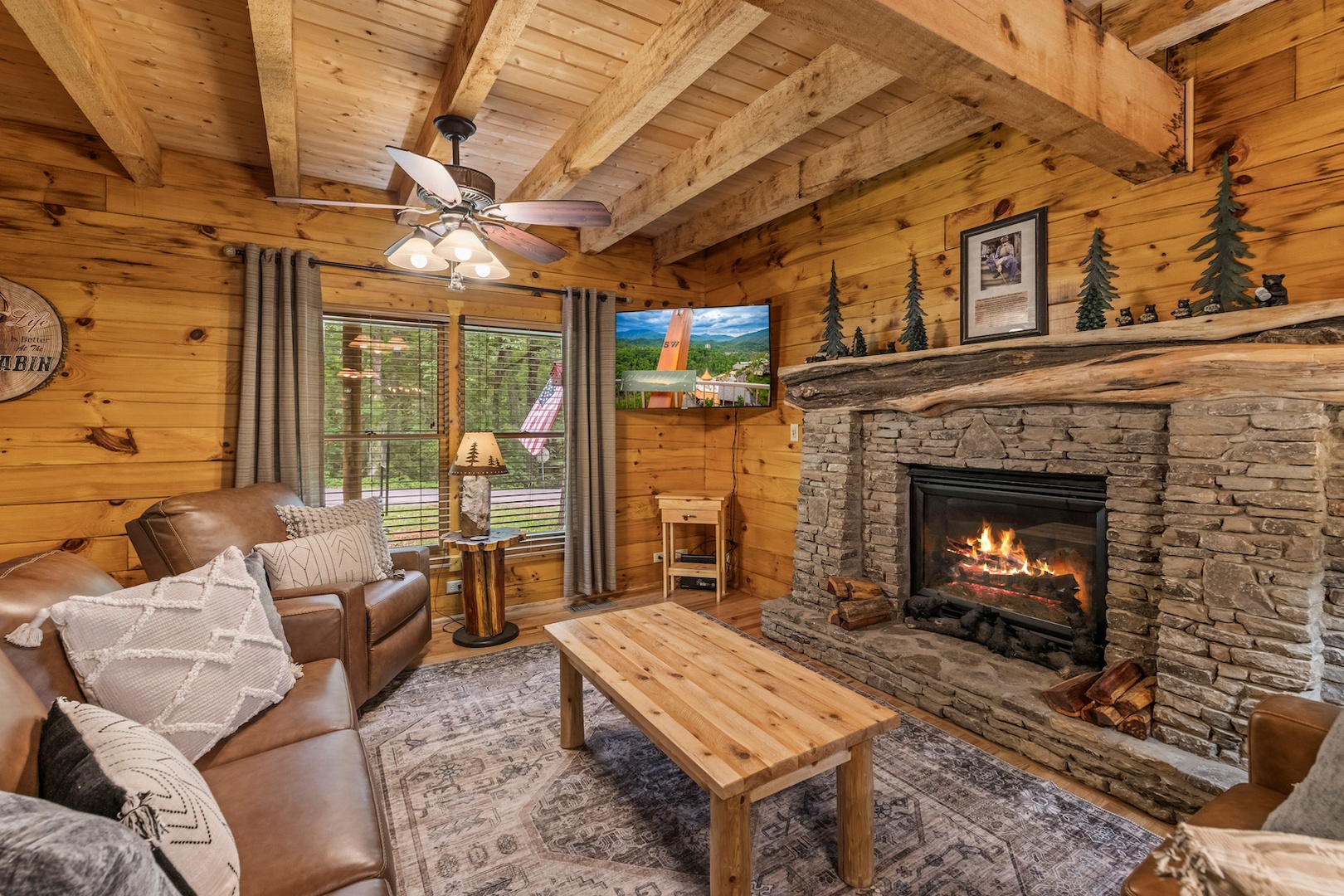 Living area with leather seating, gas fireplace, and Smart TV