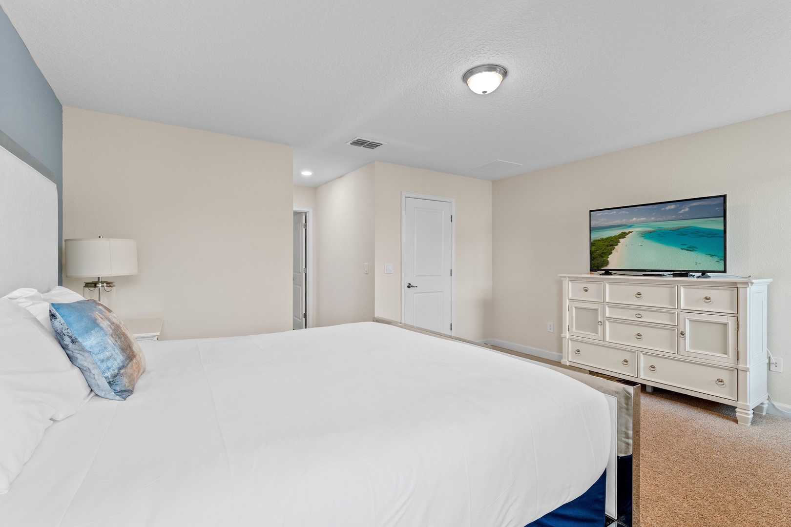 Bedroom 4 with king bed, TV, and ensuite
