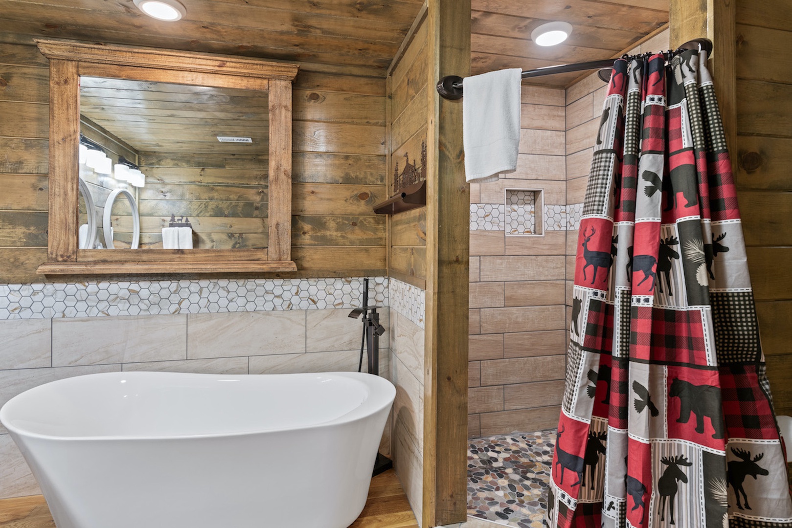 This spacious ensuite includes a double vanity, shower, & soaking tub