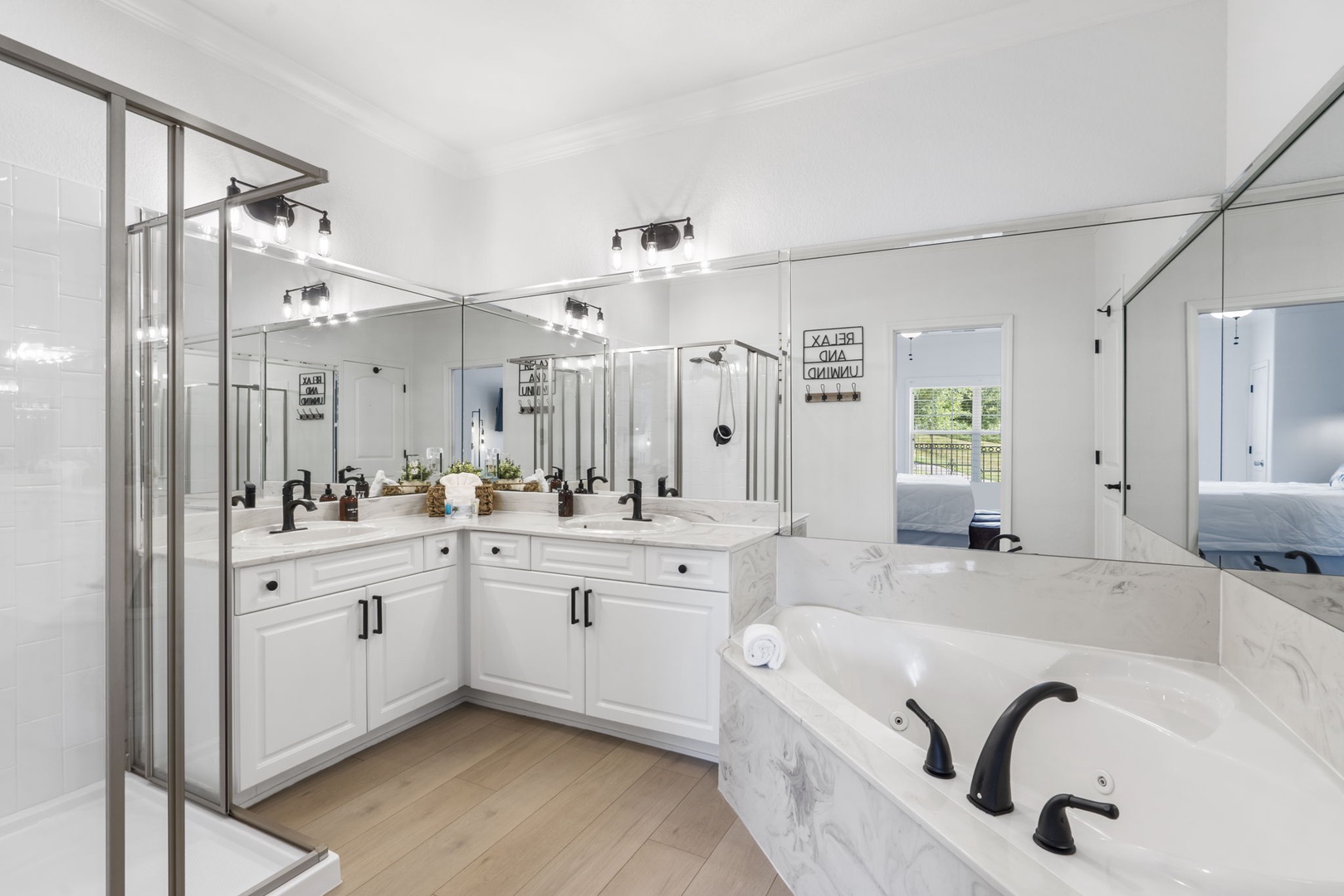King ensuite boasts a large double vanity, standing shower and a jetted tub