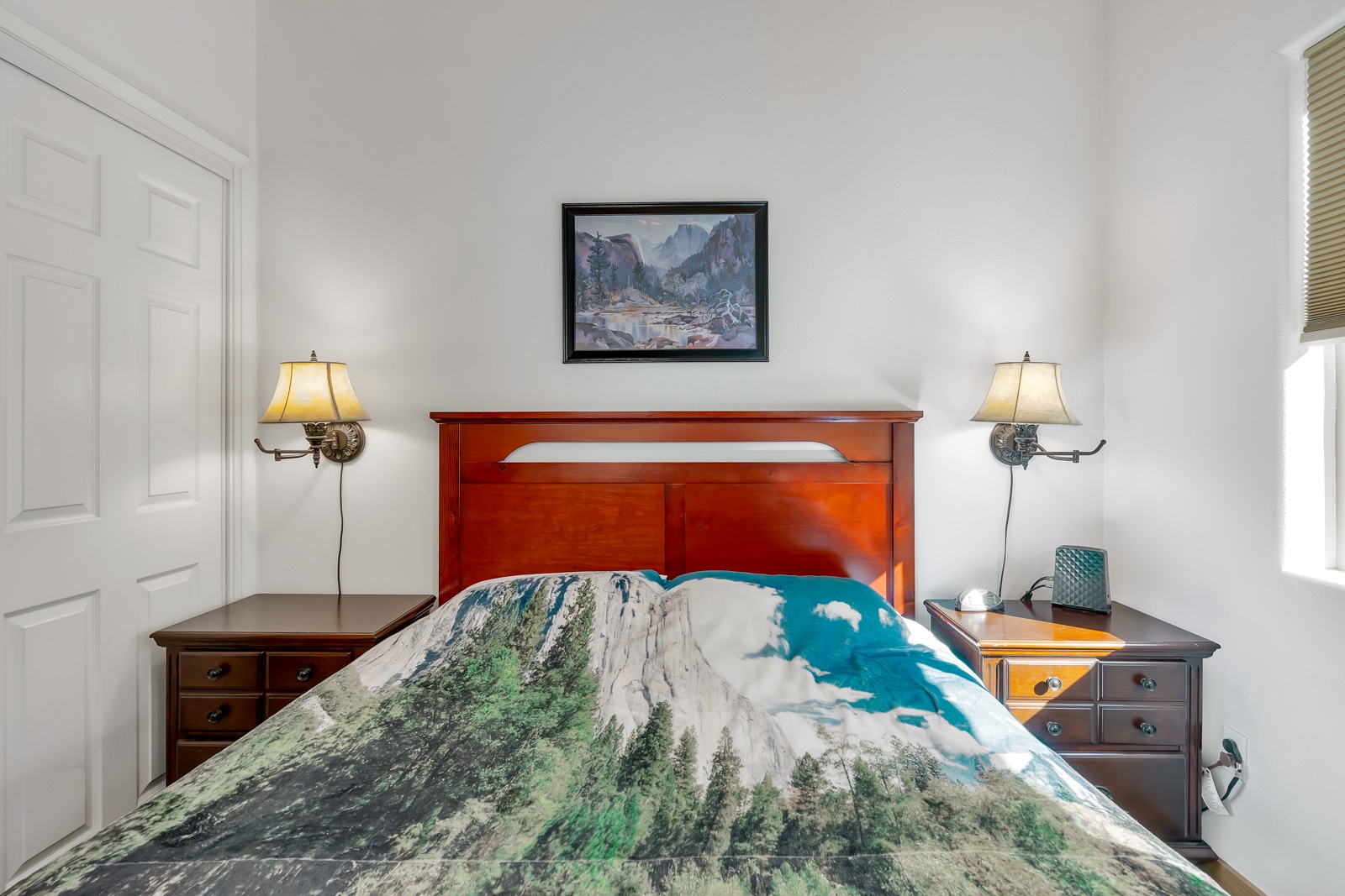 The private bedroom offers soaring ceilings & a regal queen-sized bed