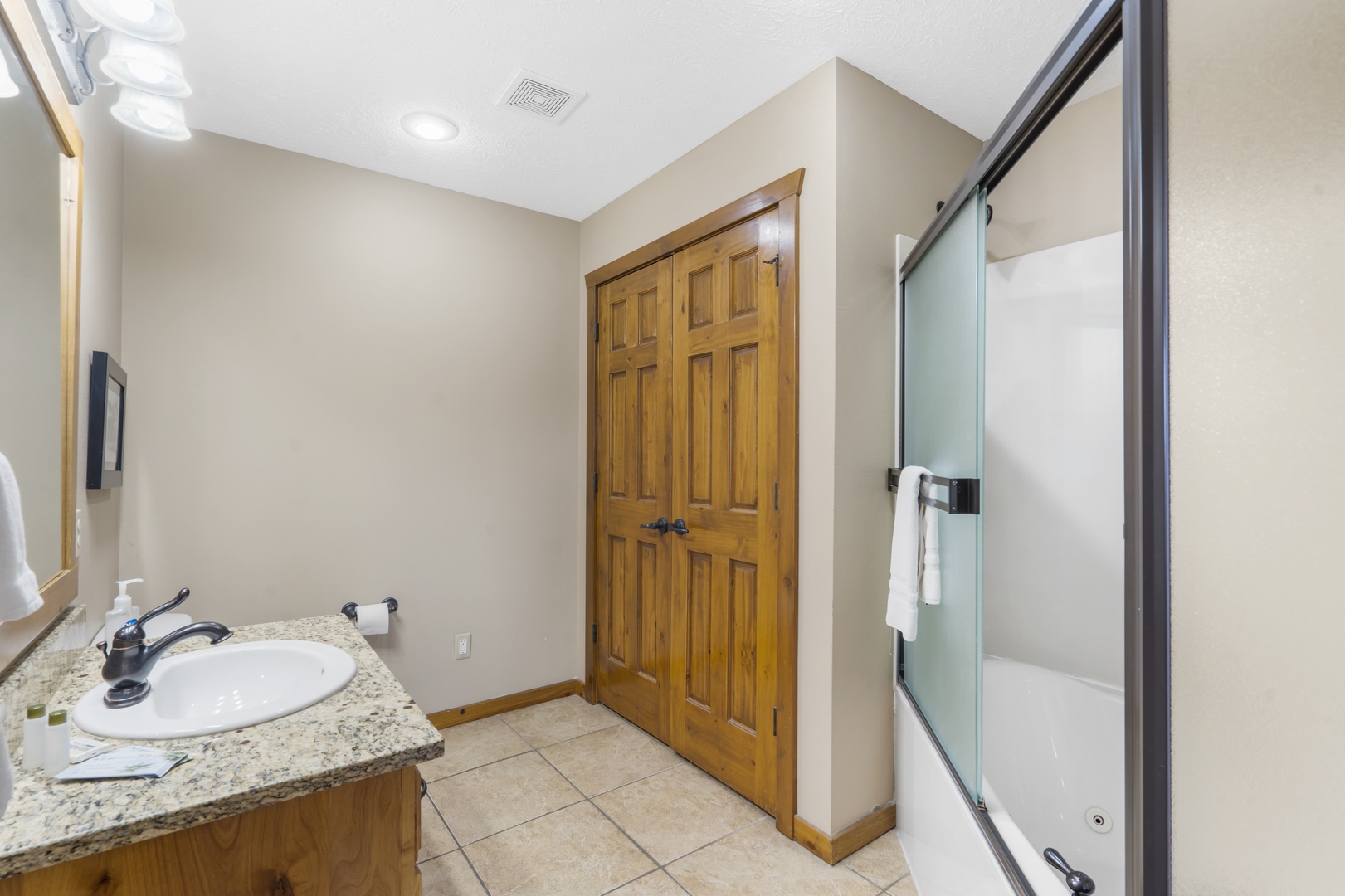 A single vanity & oversized shower/tub combo are available in this ensuite