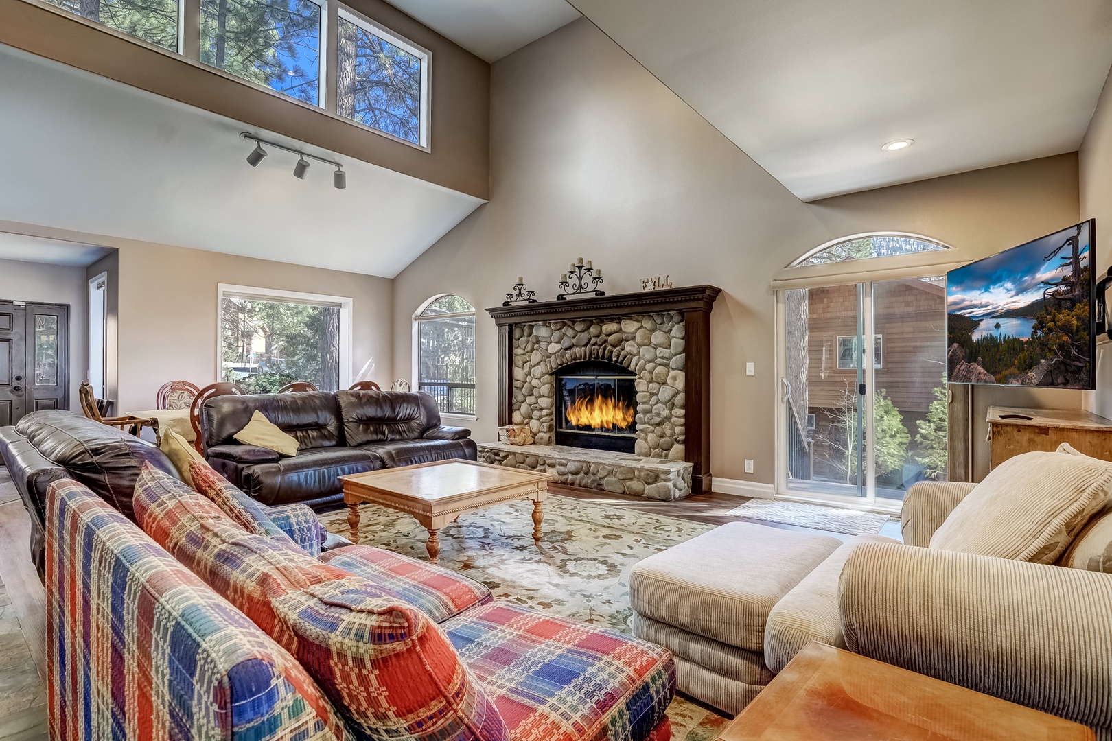 Living room with Samsung Smart TV, wood burning fireplace, and plenty of seating