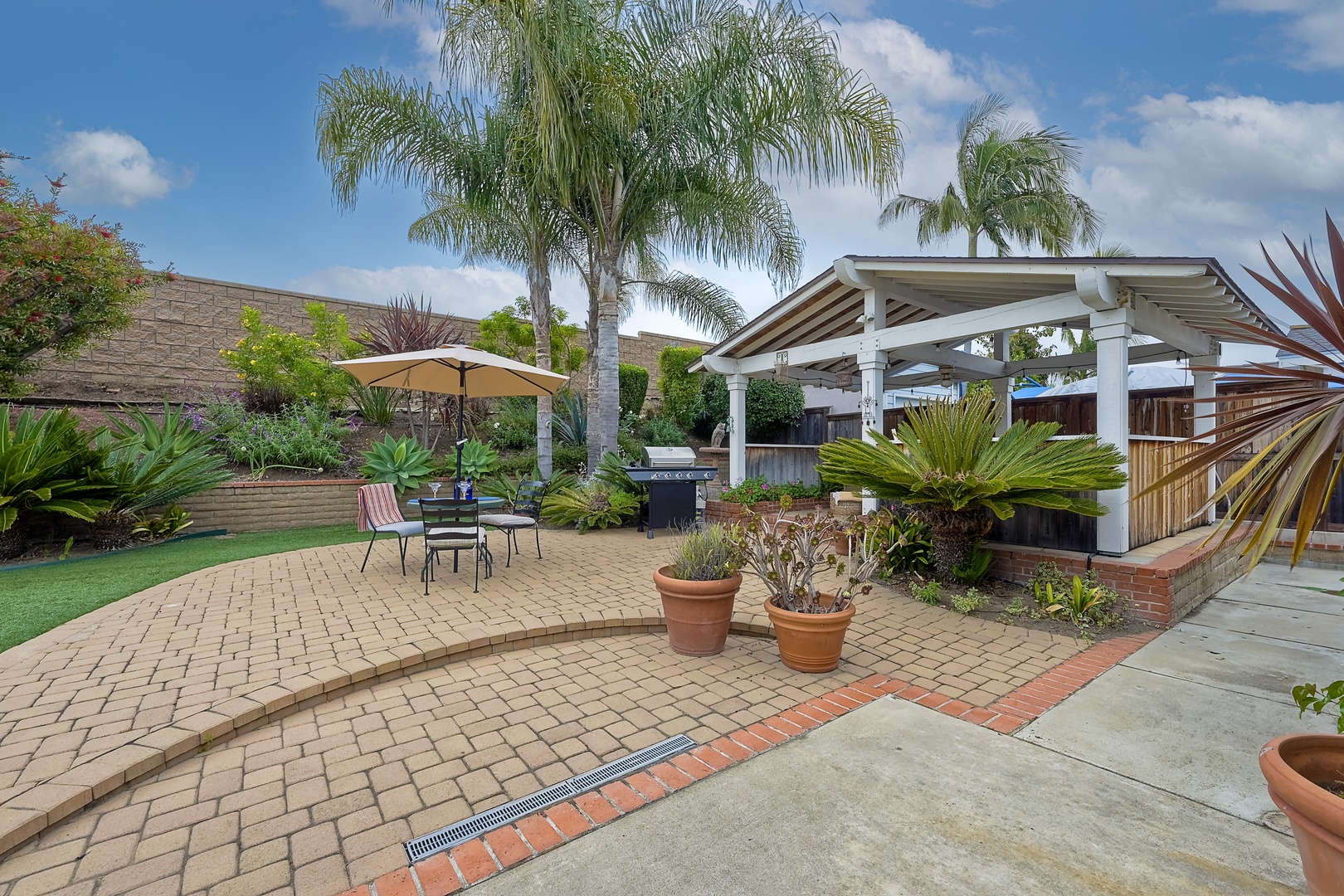 Experience serenity in the backyard oasis, ideal for gatherings & alfresco dining