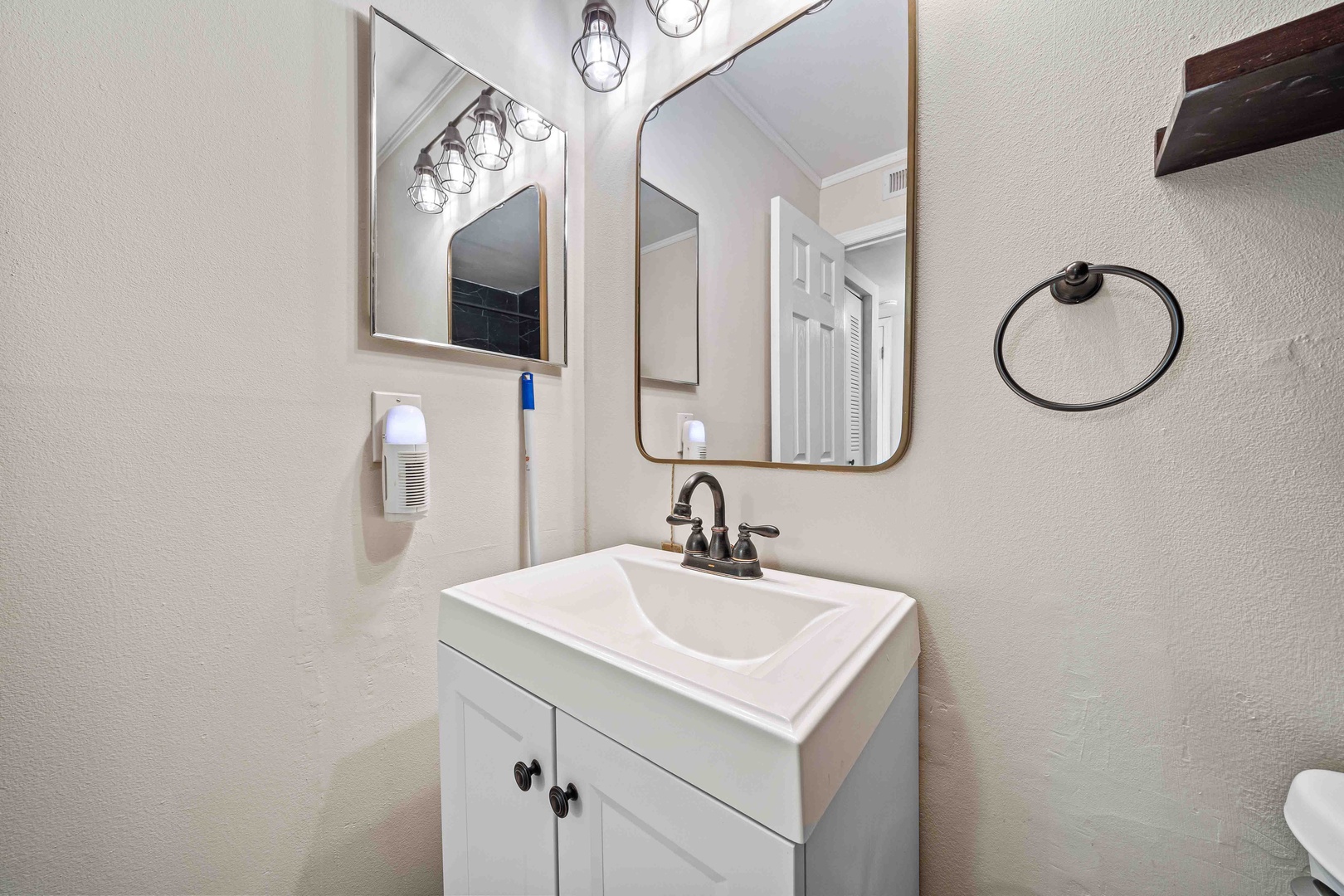 A single vanity, walk-in shower await in the ensuite bath