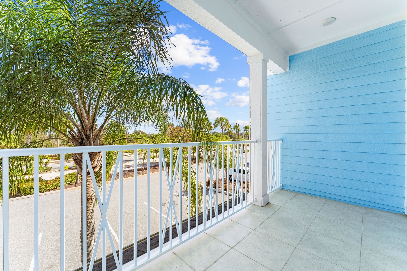 Step onto the 2nd-level balcony & enjoy the fresh air & palm trees