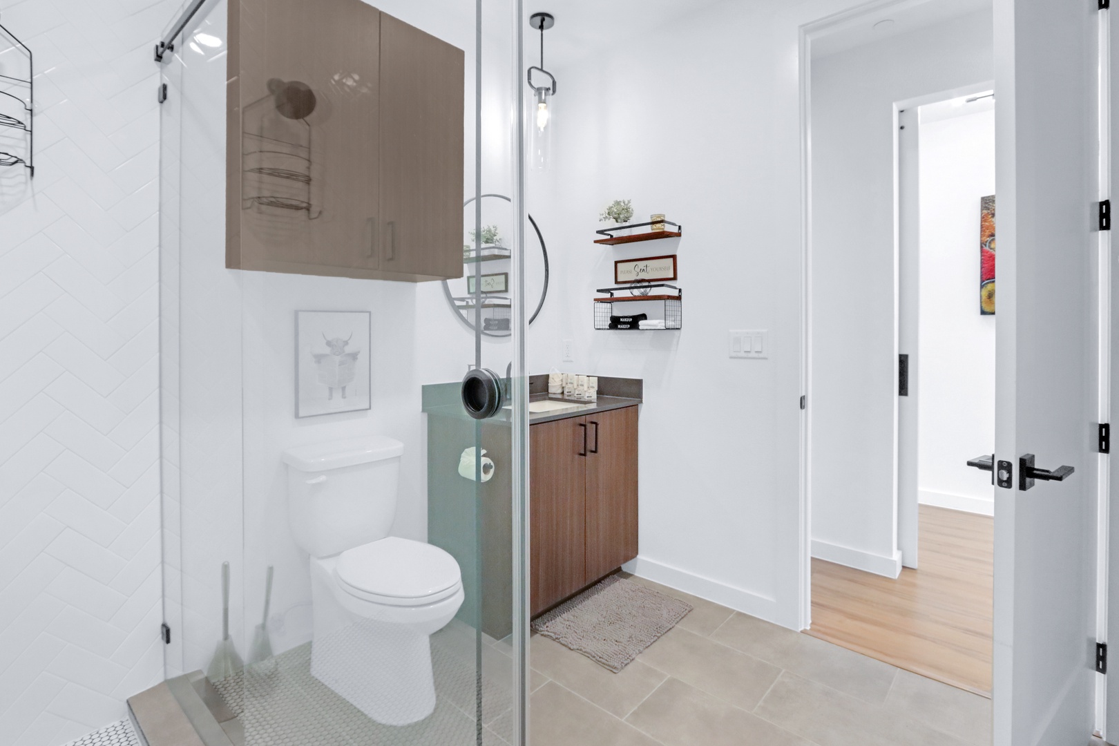 A single vanity & glass shower awaits in the full bathroom