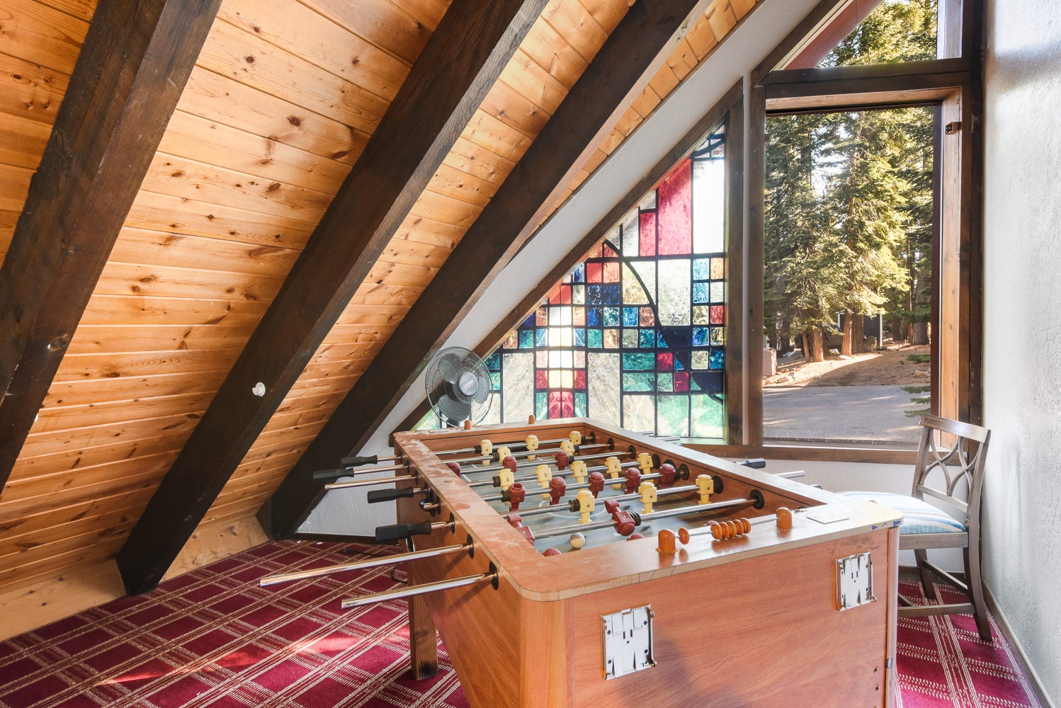 Loft with Full bed, Smart TV, desk, and foosball table