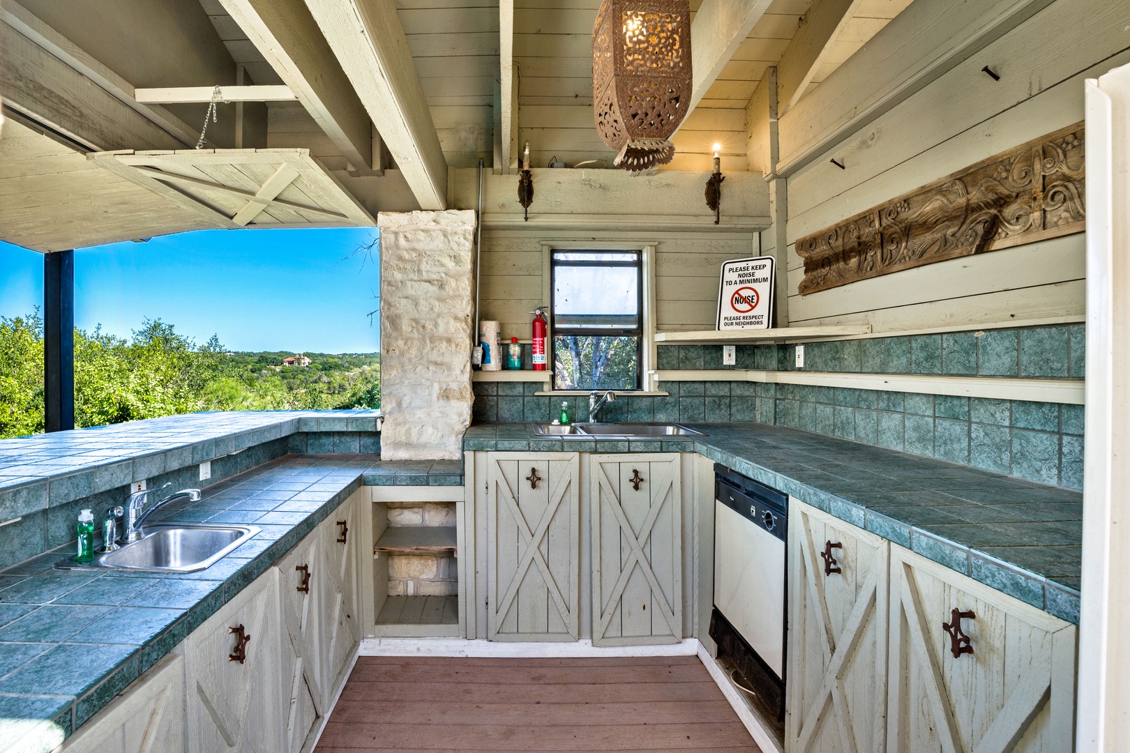 Outdoor kitchenette with sinks, dishwasher, and refrigerator