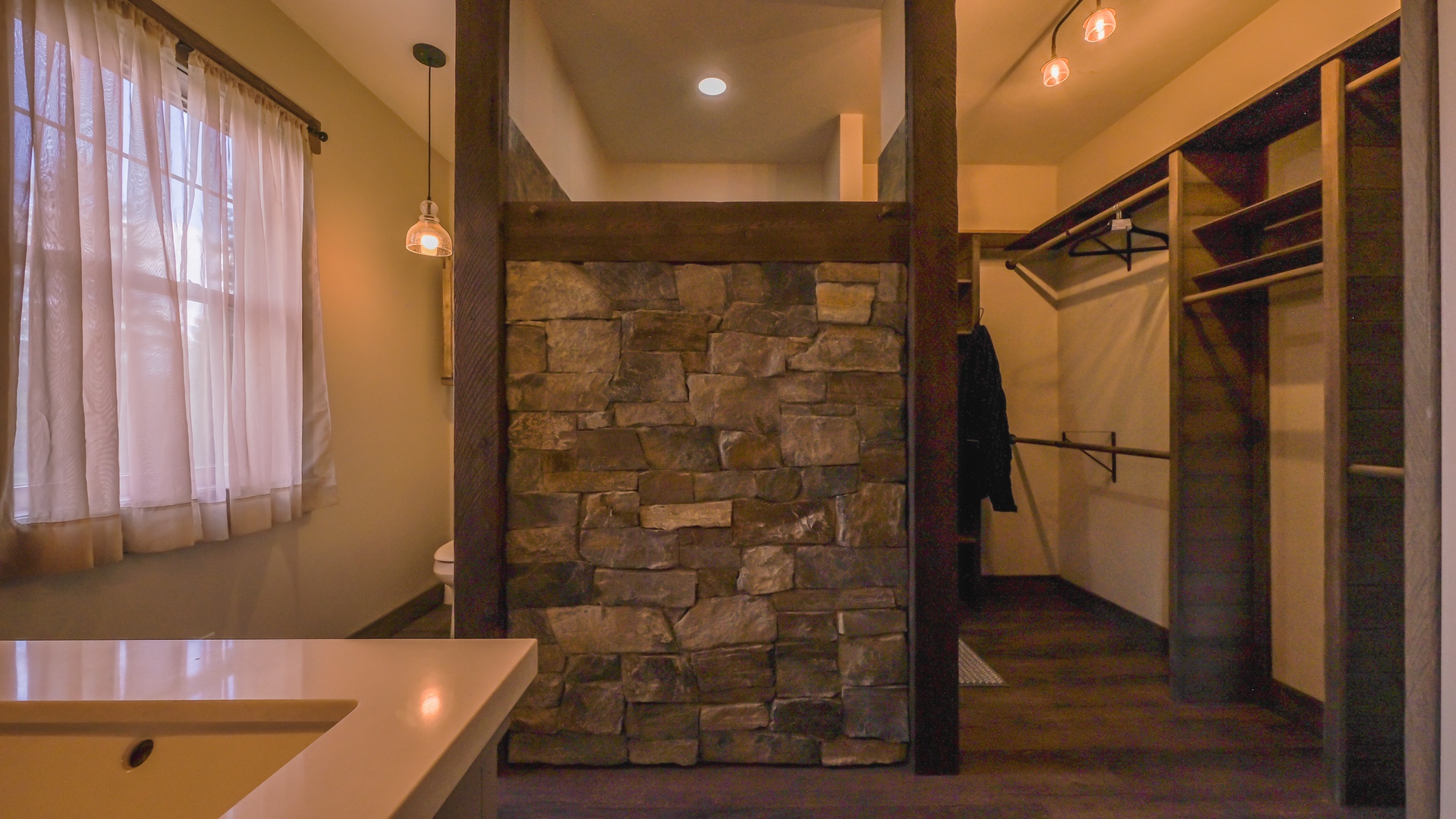Ensuite bathroom with stunning stonework, dual sinks and stand-up shower