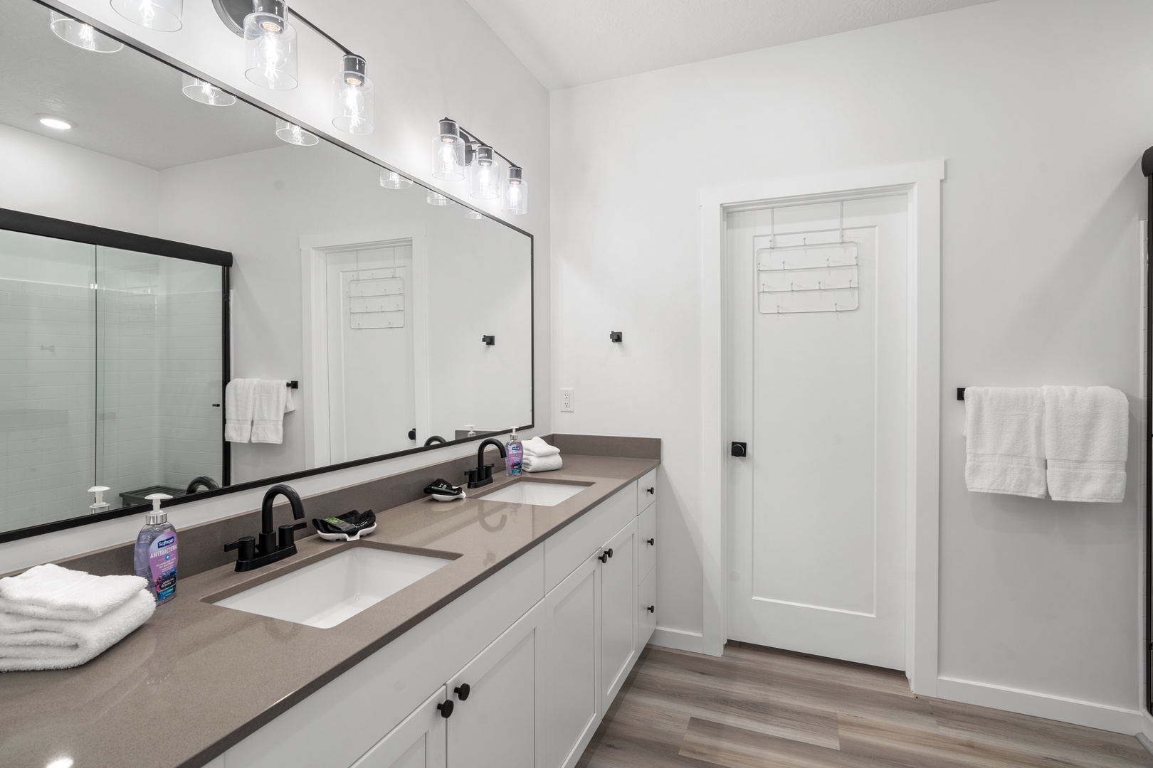 The first bedroom’s ensuite features a dual vanity, shower, & walk-in closet