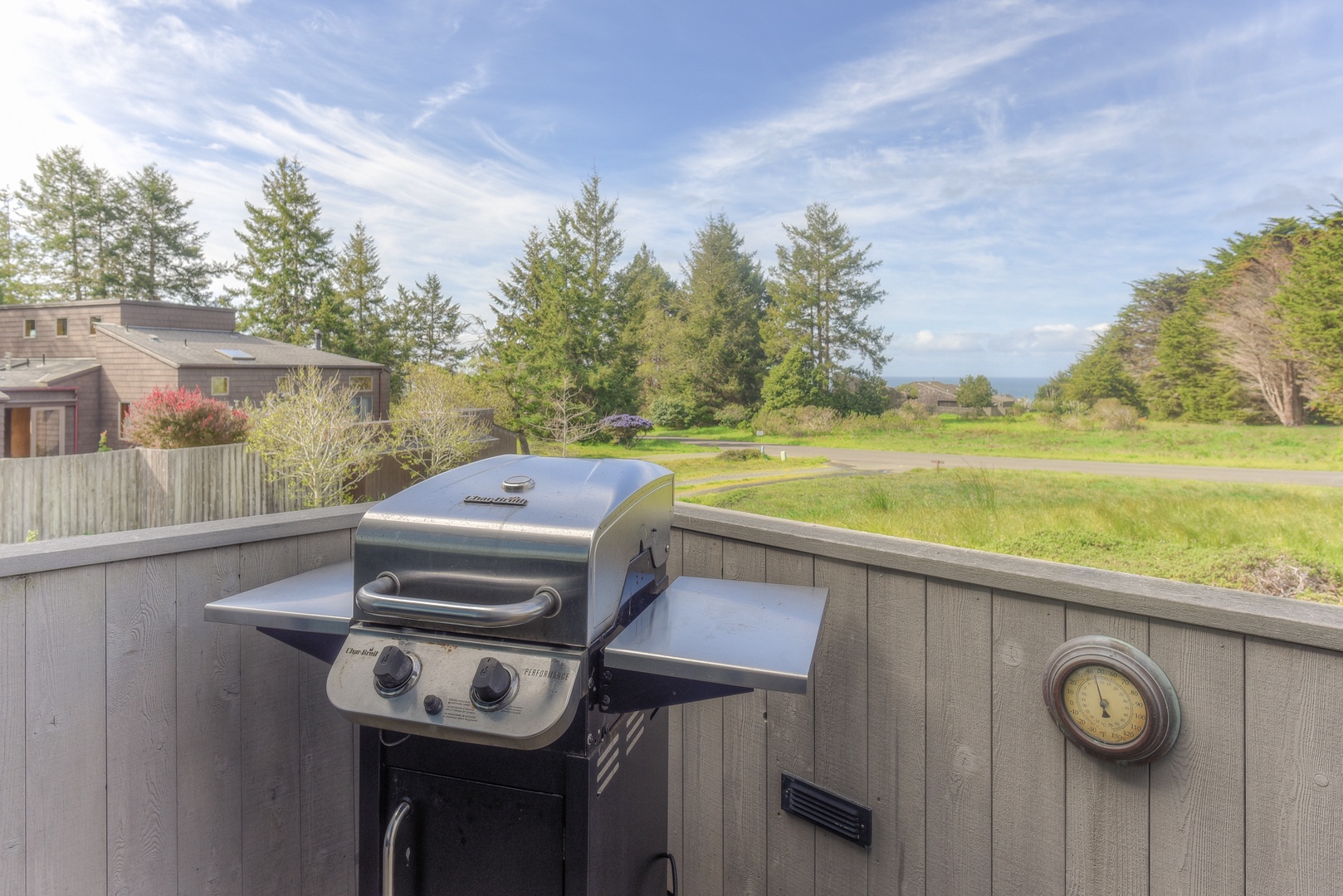 Spacious deck with outdoor seating, grill, and hot tub