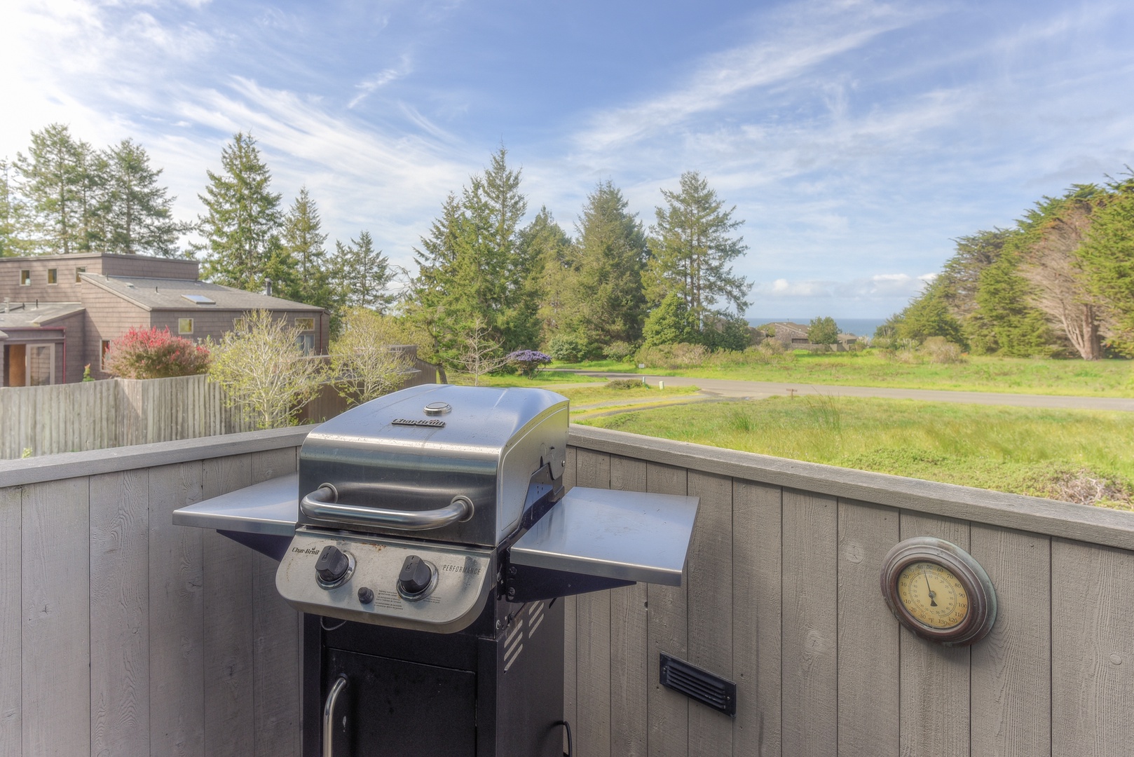 Spacious deck with outdoor seating, gas grill, and hot tub