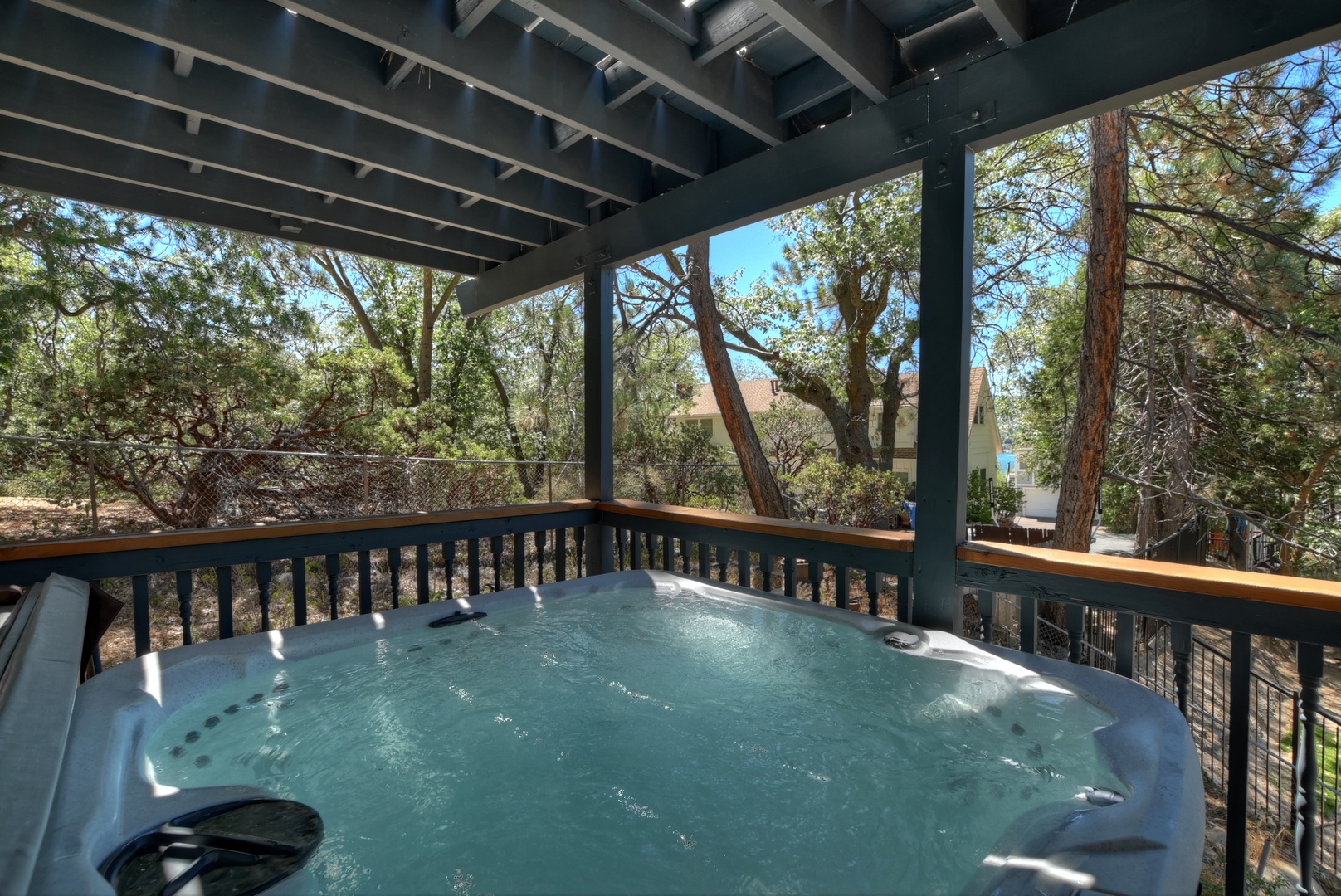 Deck with hot tub, seating, and hammock