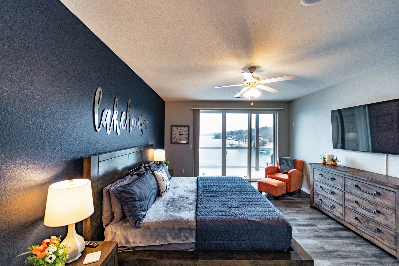 The master suite boasts a king bed, private ensuite, TV, & balcony access