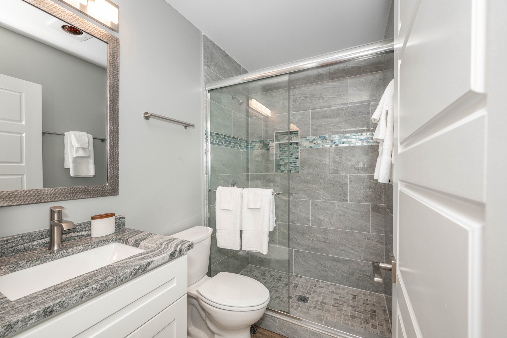 This ensuite bath includes a single vanity & shower/tub combo