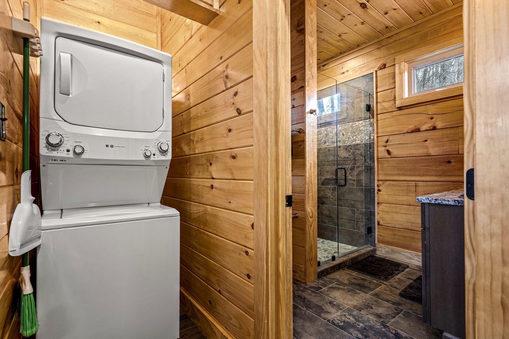 Shared bathroom with stand-up shower, and laundry area