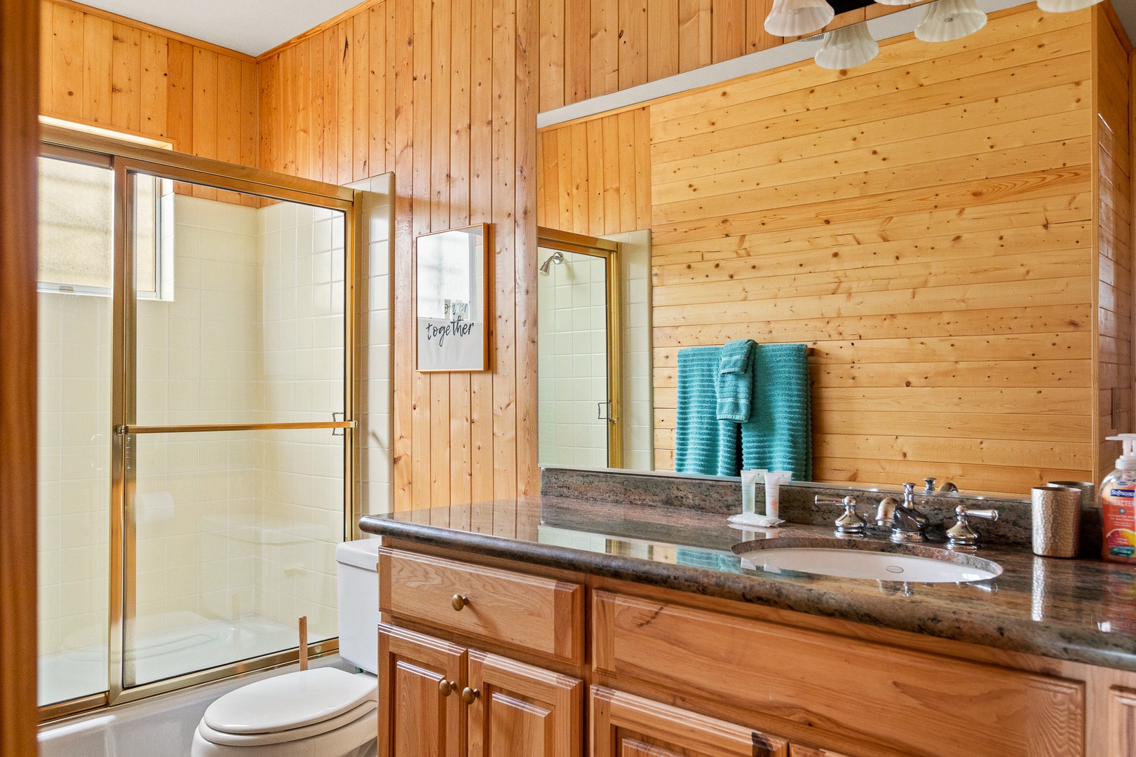 Spacious, light-filled bathroom offering ample counter space and Shower/Tub Combo