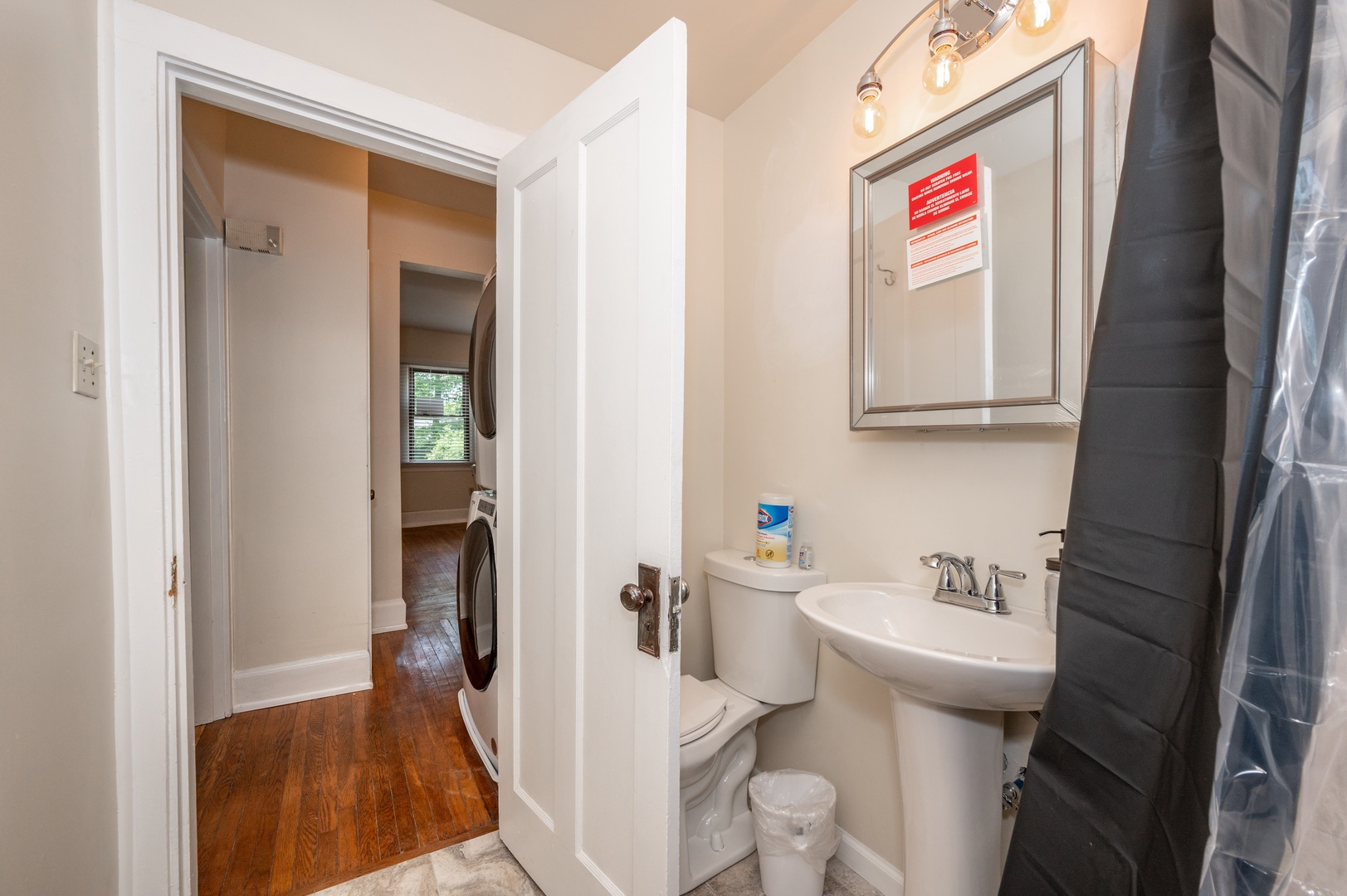 A pedestal sink & shower/tub combo await in the full bathroom