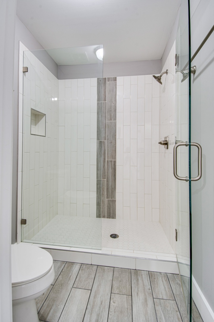 En suite bathroom with dual sinks and standing shower