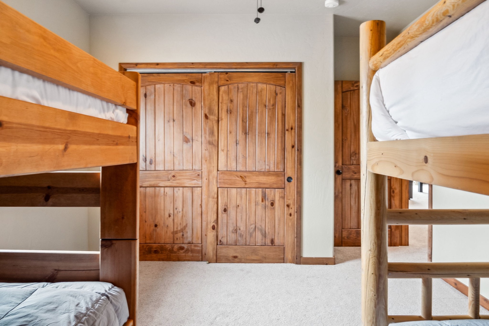 This lower-level bedroom offers a pair of cozy twin bunkbeds