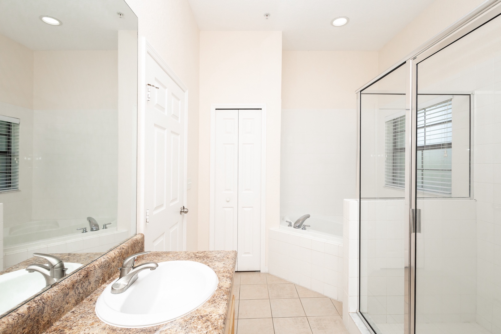 The king en suite offers a dual vanity, glass shower, & luxurious soaking tub