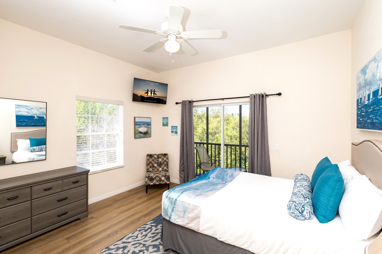The 2nd bedroom offers a plush queen bed, balcony, Smart TV, & attached bath