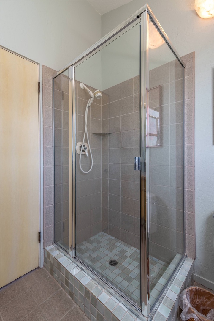 En suite master bathroom with dual sinks and standing shower