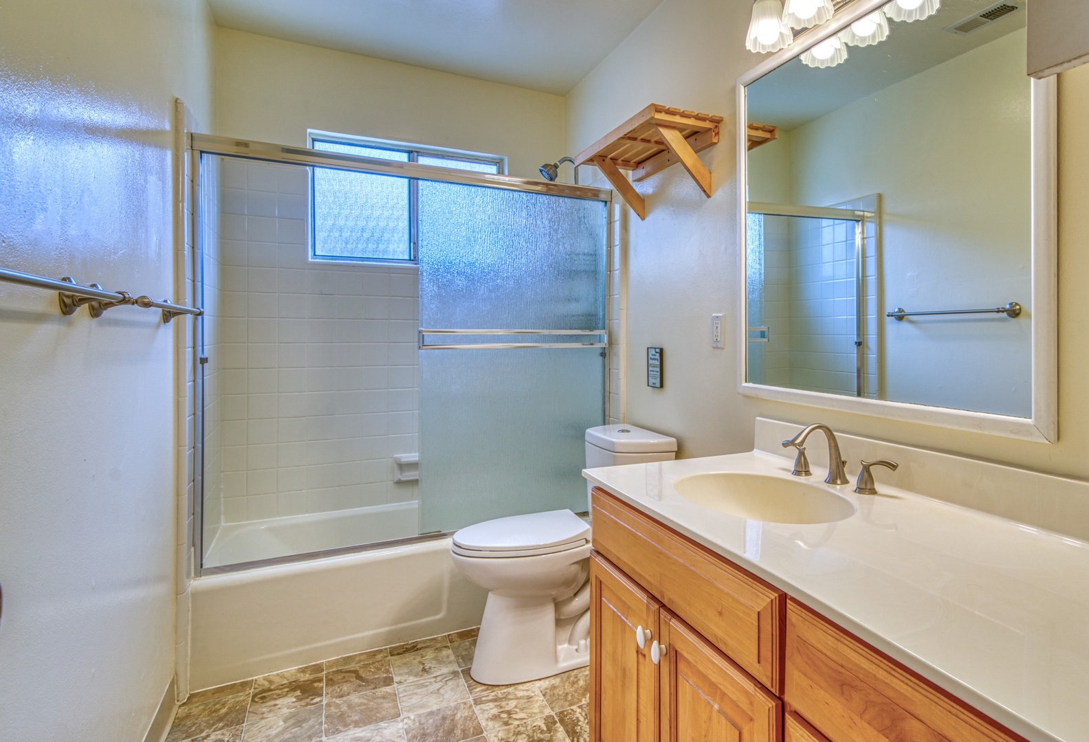 The full bath features a large single vanity & shower/tub combo