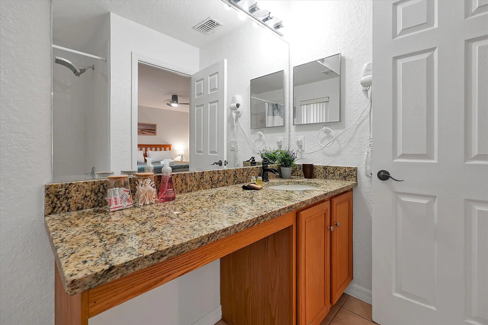 Prepare for the day in this ensuite, offering a large vanity & shower/tub combo