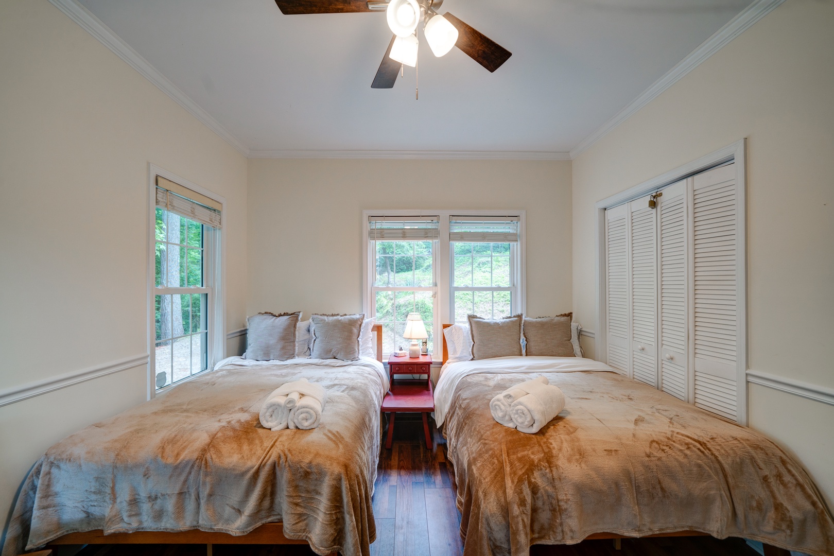 A pair of plush full-sized beds & a Smart TV awaits in this bedroom retreat