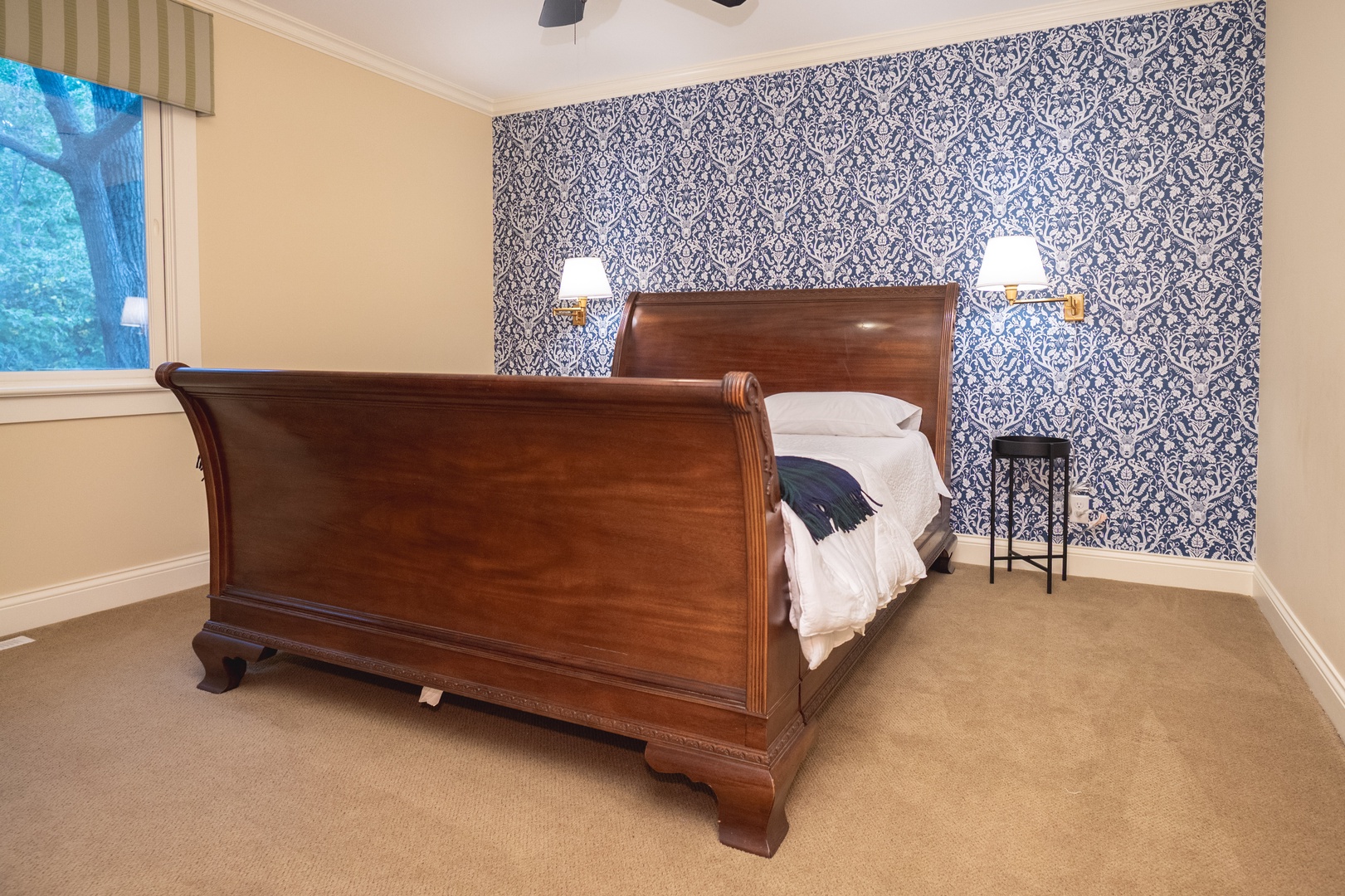 This 2nd floor bedroom offers a queen bed, ceiling fan, & large closet