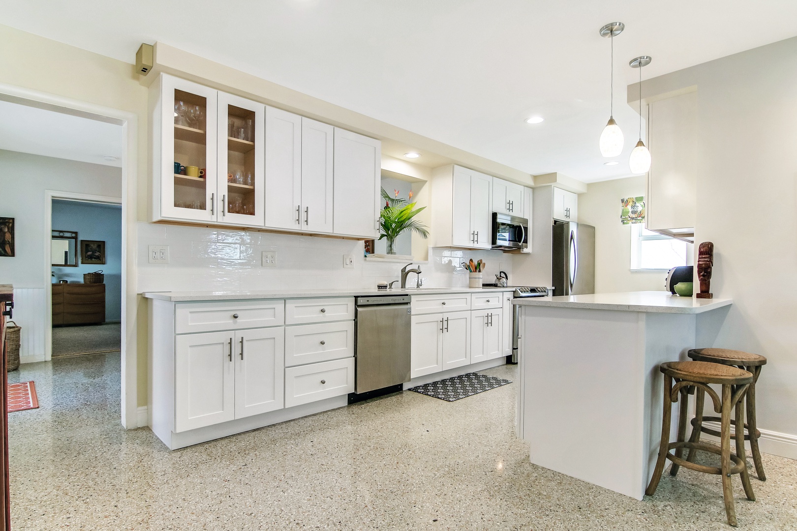 The bright, cheerful kitchen offers ample space & all the comforts of home