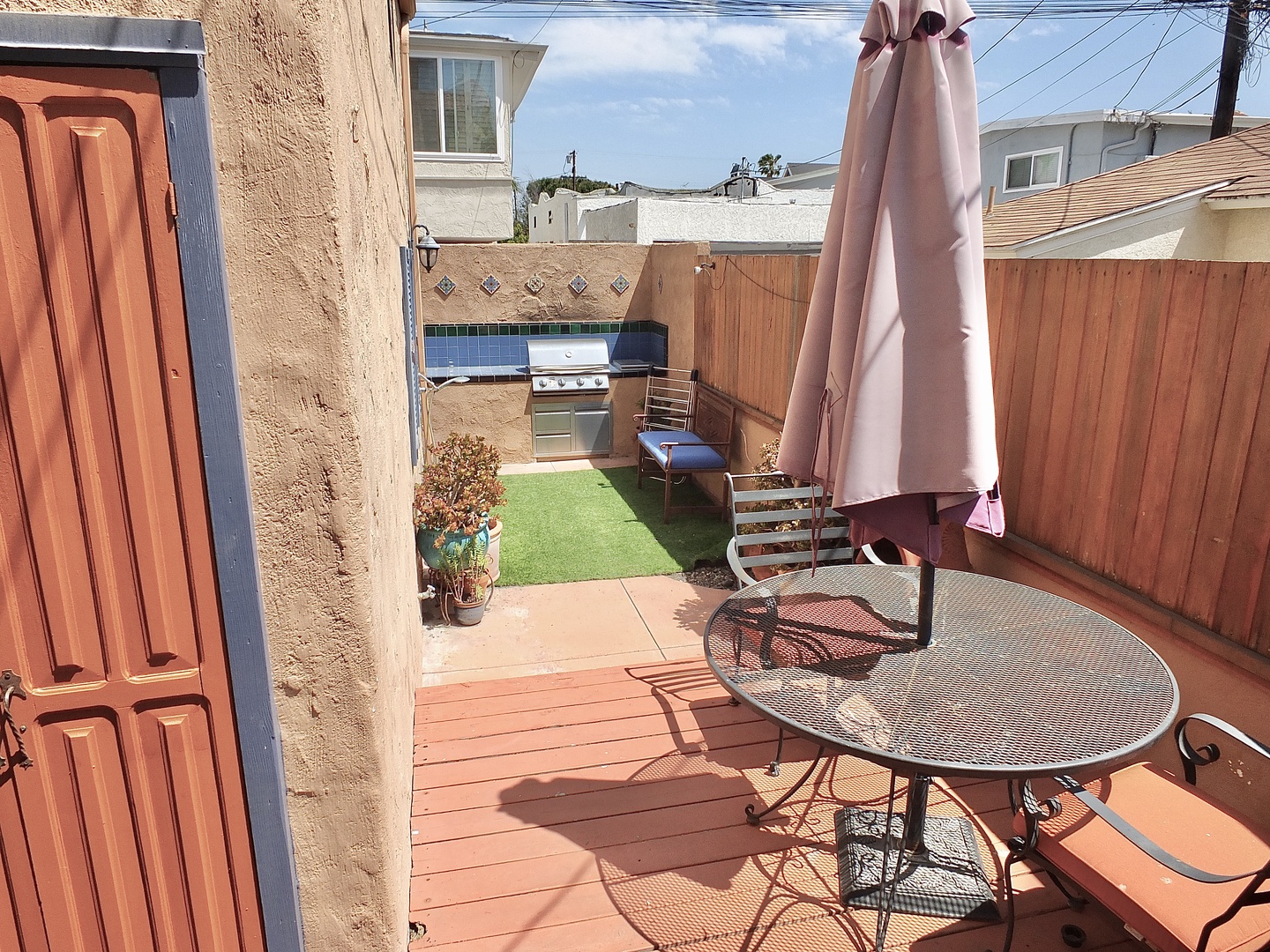 Enjoy al fresco dining in the back yard, with a gas grill and dining seating for 2