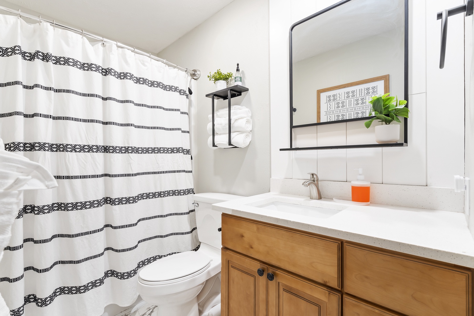 This full bathroom includes a spacious single vanity & shower/tub combo