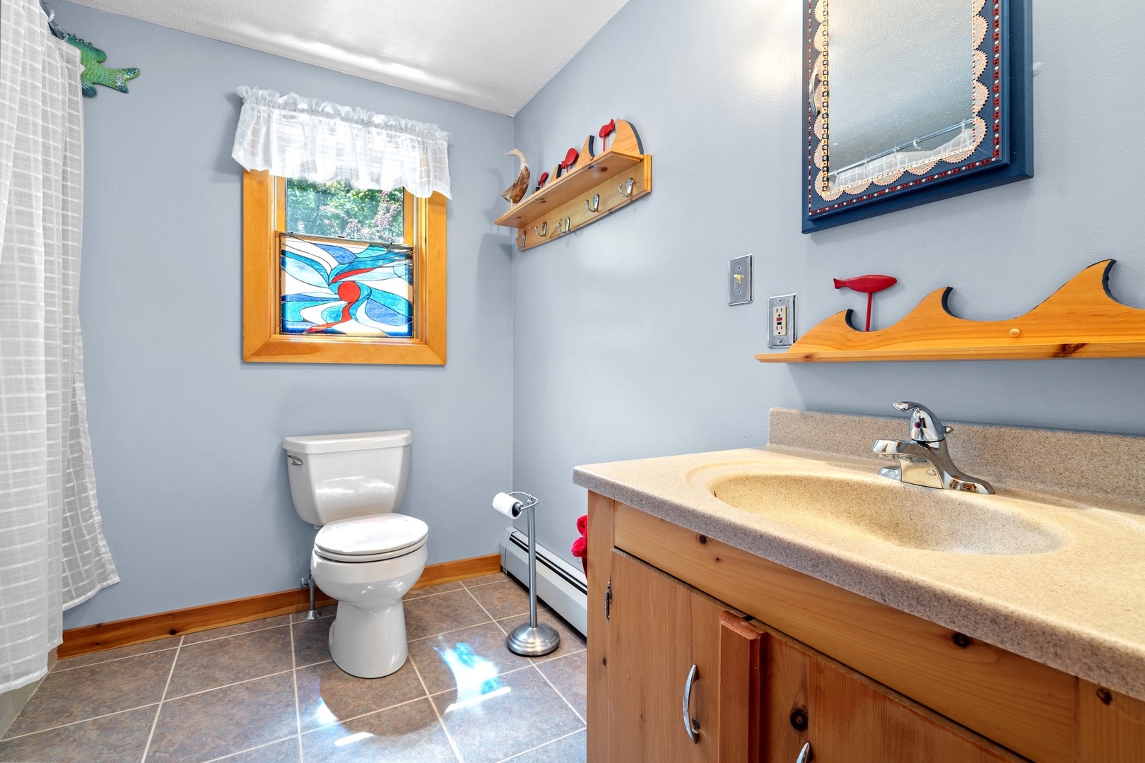 A shower/tub combo & large single vanity await in this ensuite bath