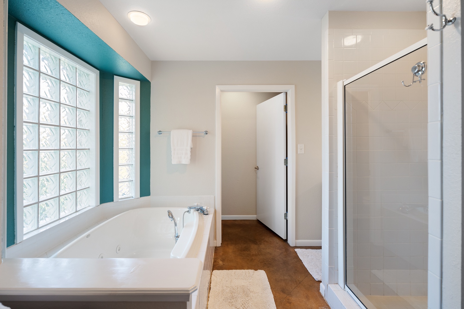 The king en suite boasts a jetted soaking tub and glass shower