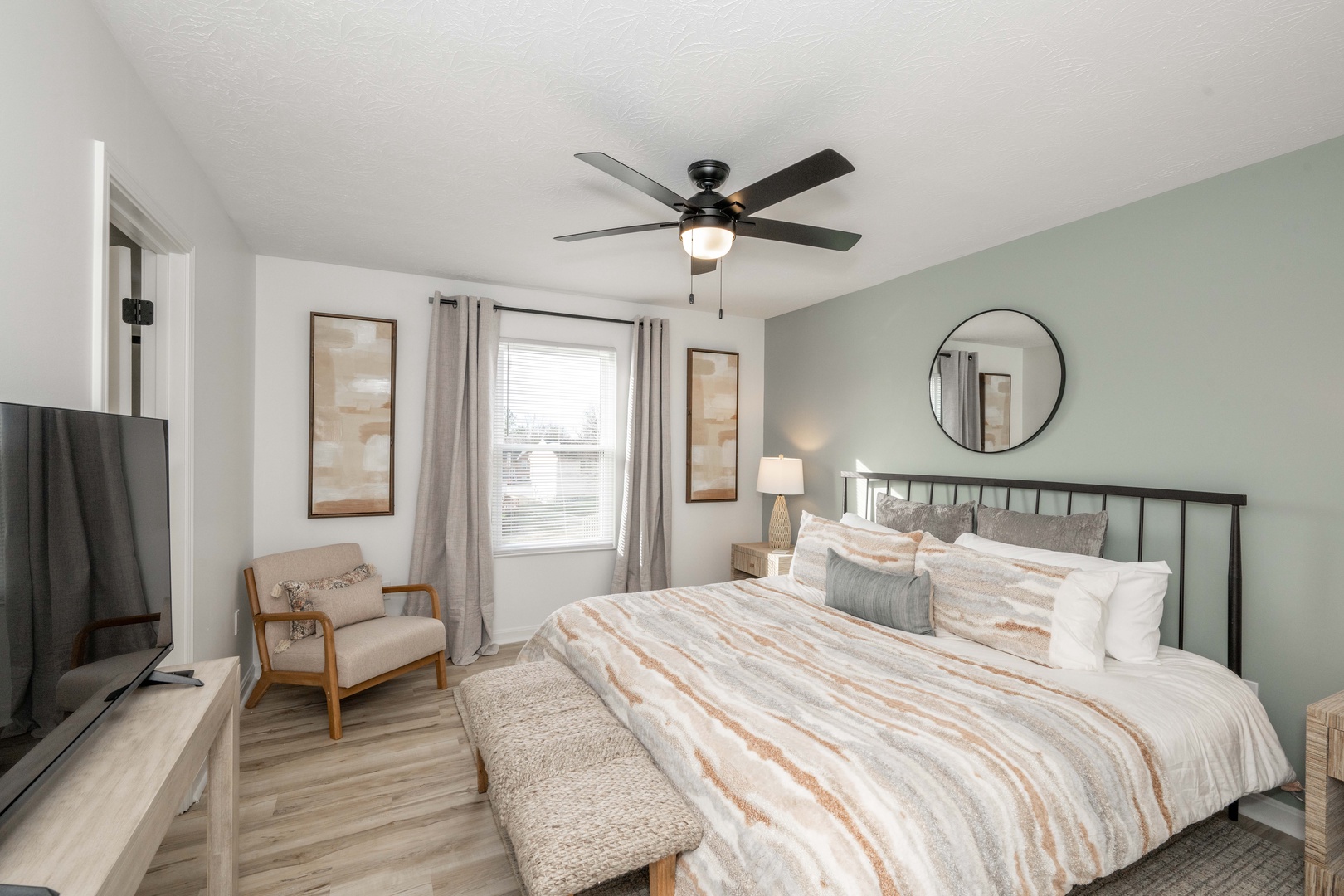 This calming bedroom retreat boasts a private ensuite, king bed, & Smart TV