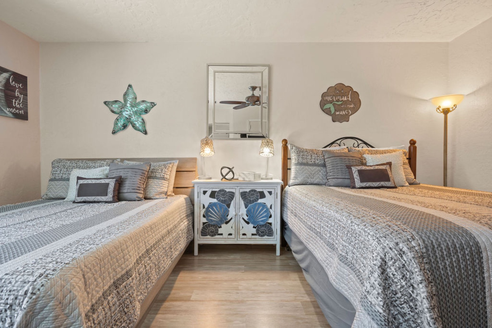 Spacious double queen bedroom with ceiling fan for added comfort