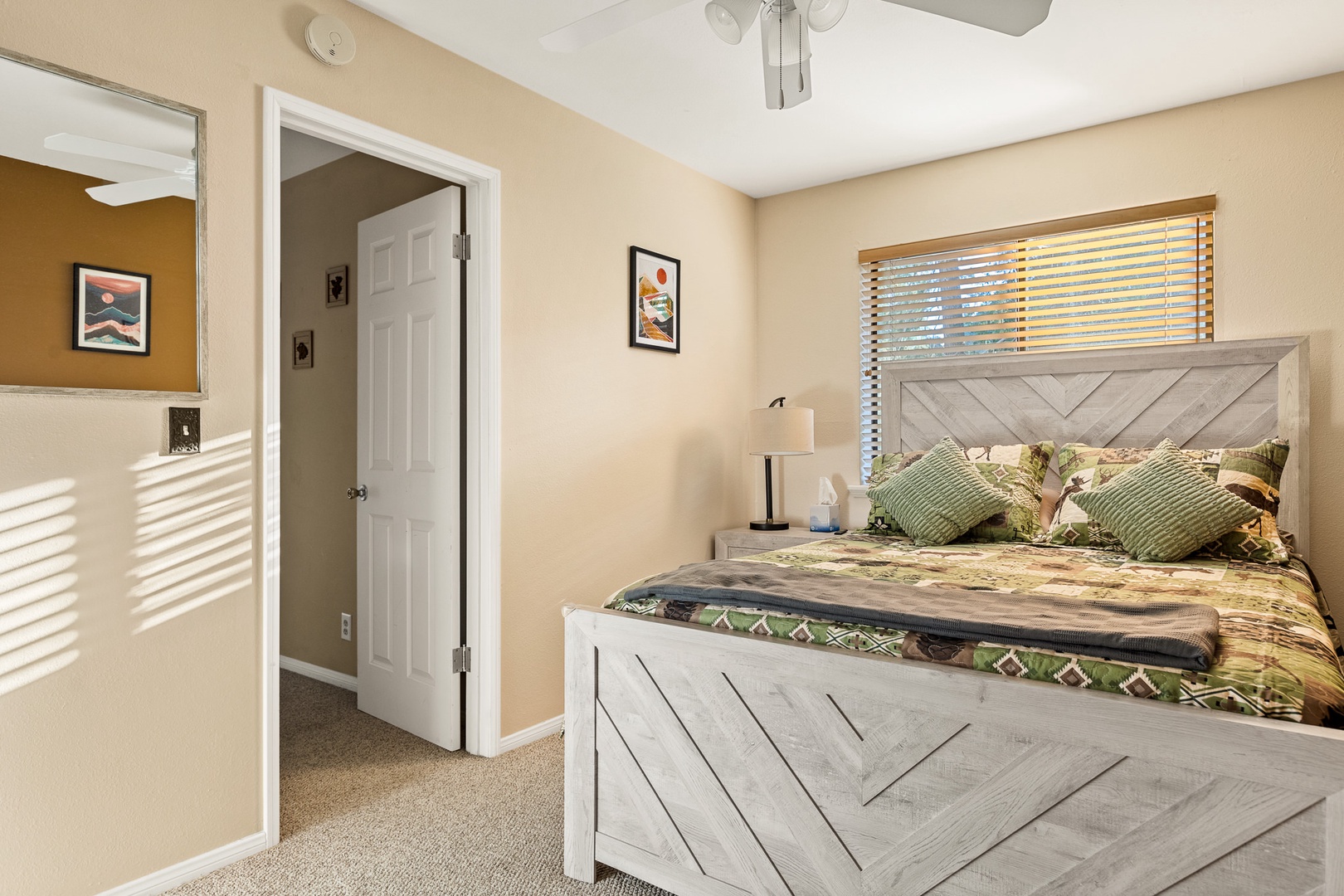 The 2nd of two bedrooms includes a queen bed, ceiling fan, & walk-in closet