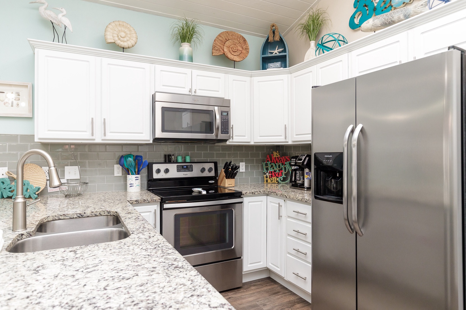 The beachy kitchen offers ample space & all the comforts of home