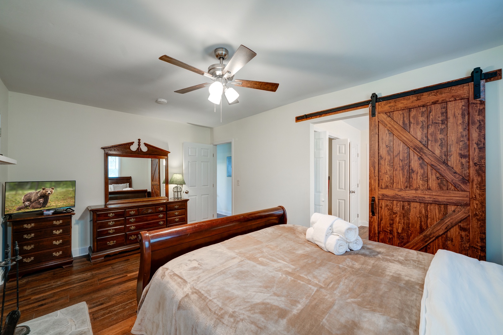 The master suite boasts a queen bed, ensuite bath with laundry, & porch access