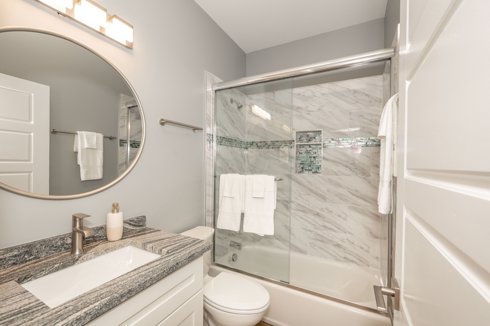 This home’s stylish full bath includes a single vanity & shower/tub combo