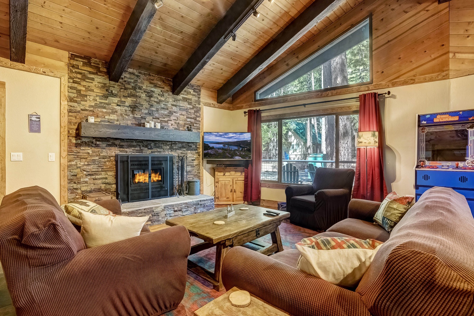 Living room with Smart TV, wood burning fireplace, backyard access and comfortable seating