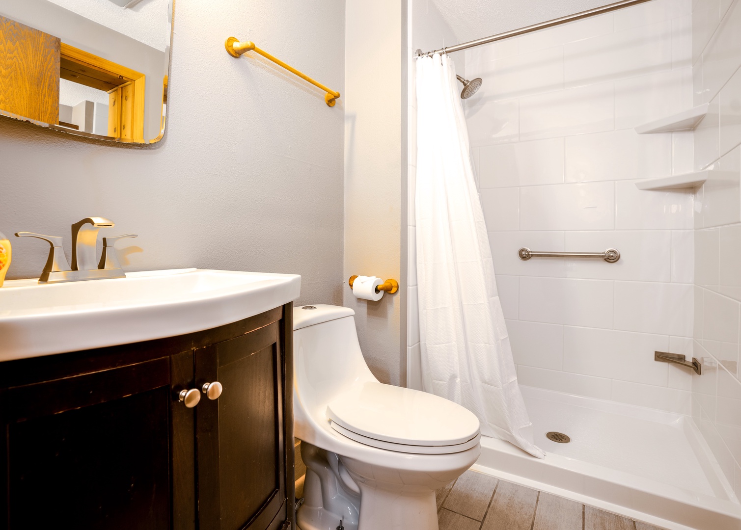 The primary suite contains a single vanity and walk in shower