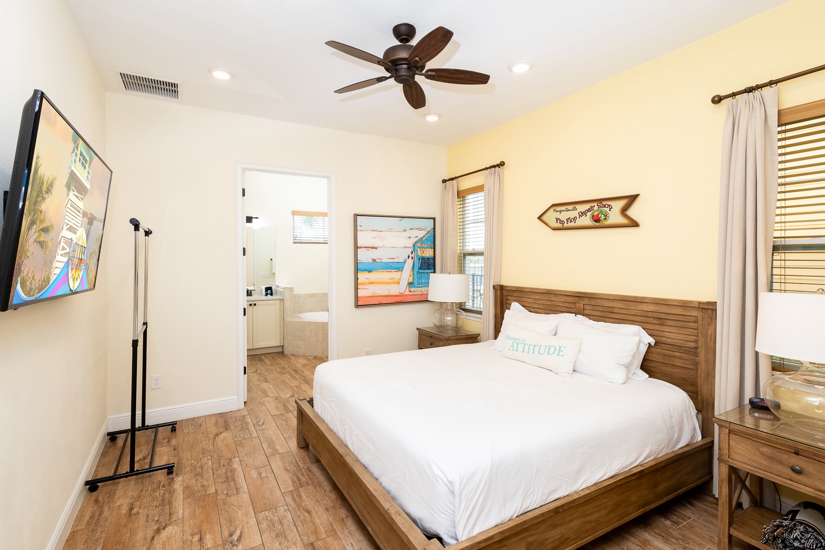 This beachy main-floor king suite boasts a private ensuite, Smart TV, & patio access