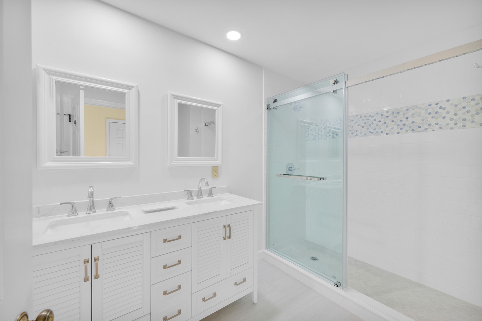 The private ensuite offers a double vanity & glass walk-in shower