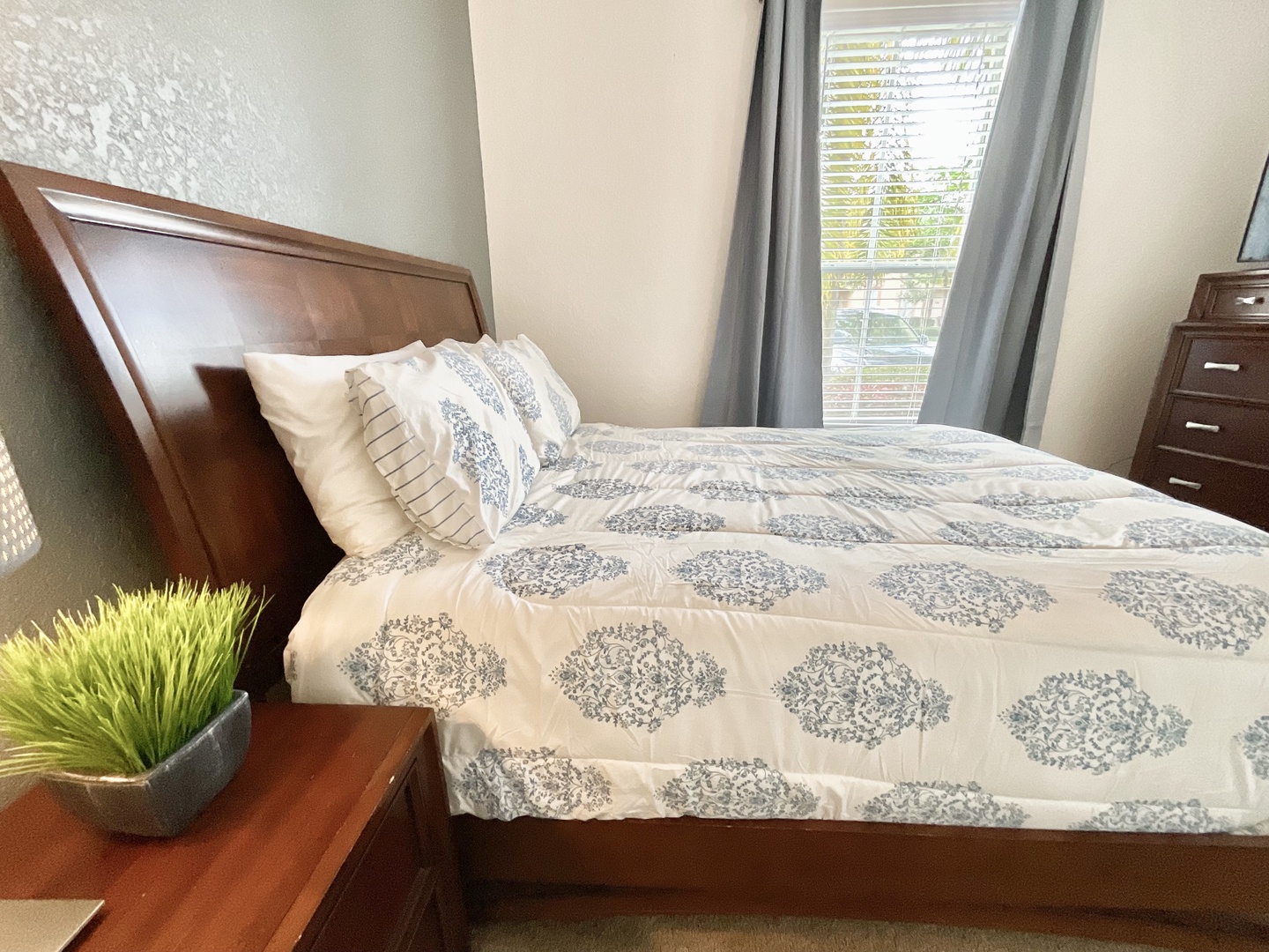 Bedroom 1 with queen bed, TV, and ensuite