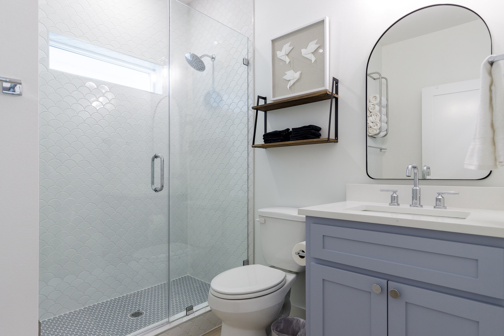 A full bathroom on the 1st floor offers a single vanity & spa-like glass shower