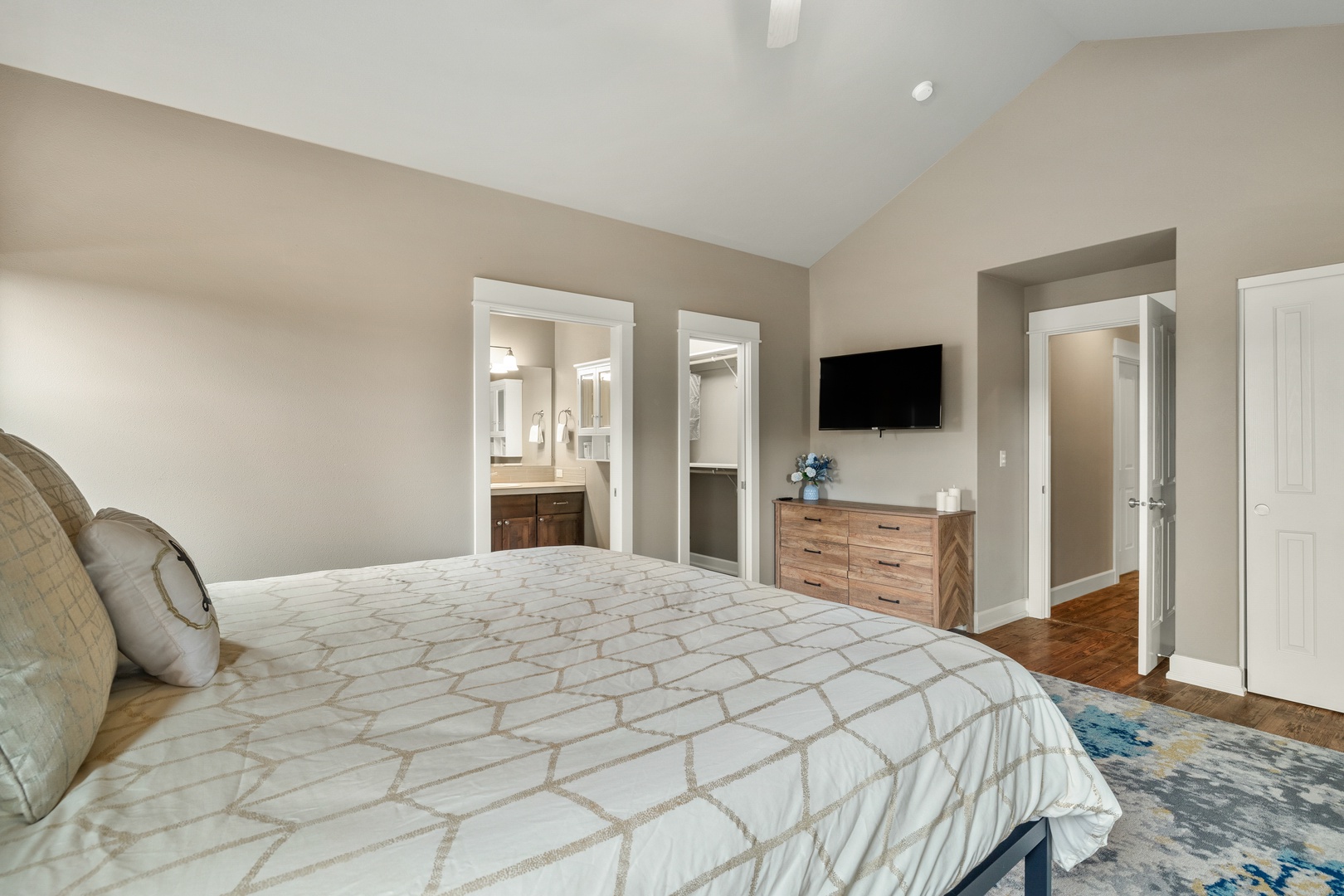 The master suite offers a king bed, private en suite, Smart TV, & patio access